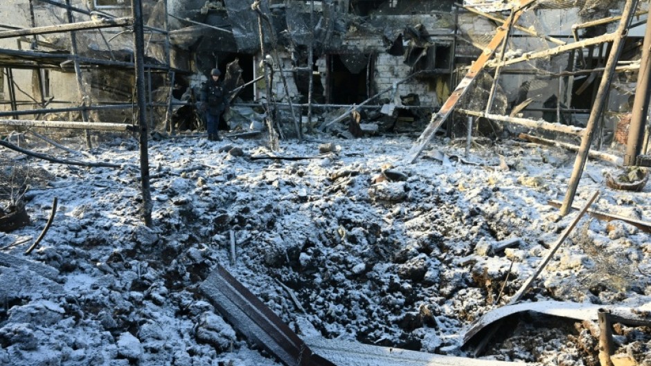 A Ukrainian rescuer works at the site of an air strike in Kharkiv