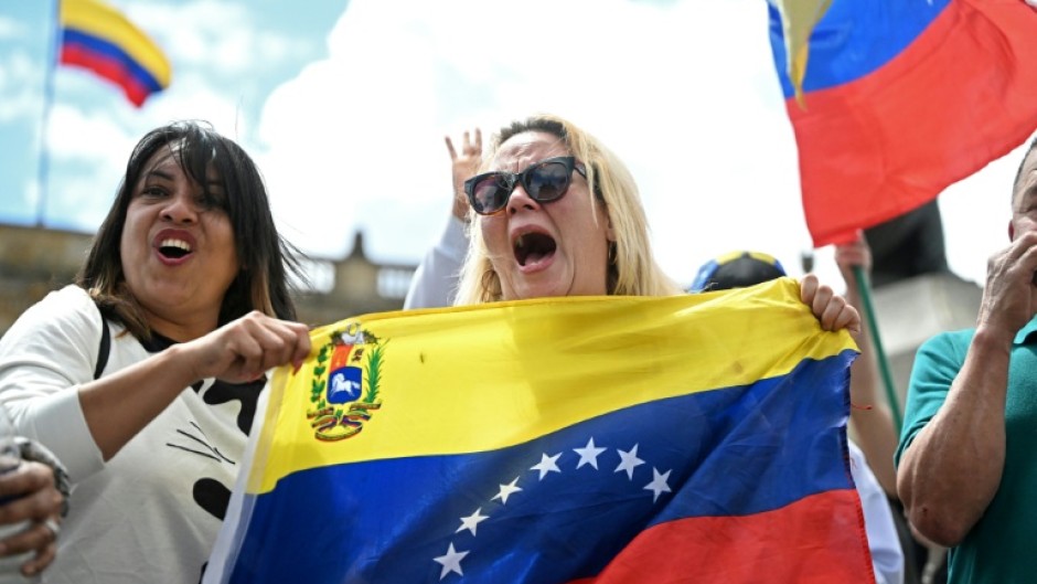 People celebrate in Bogota after US forces captured Venezuelan leader Nicolas Maduro in Caracas
