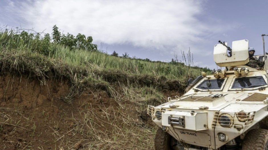 A UN peacekeeping mission armoured vehicle patrols a road in Ituri province