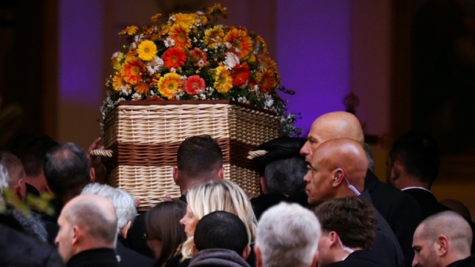 Pall-bearers carry Bardot's coffin into the Notre-Dame de l'Assomption church