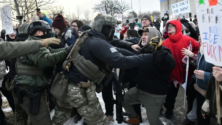 Protestors clash with federal agents outside the Bishop Henry Whipple Federal Building in Saint Paul, Minnesota, on January 8, 2026