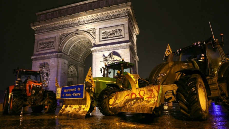 A few dozen tractors arrived before dawn and cruised through Paris, with some reaching the Eiffel Tower and others at the Arc de Triomphe