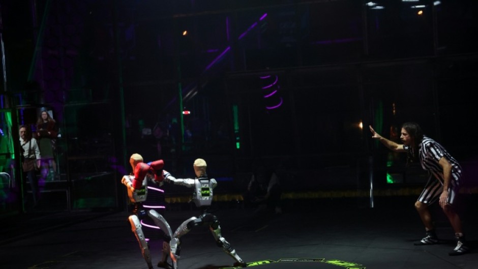 Robots mirroring movements of their human "pilots" exchange punches during the Ultimate Fighting Bots competition on the sidelines of the annual Consumer Electronics Show in Las Vegas