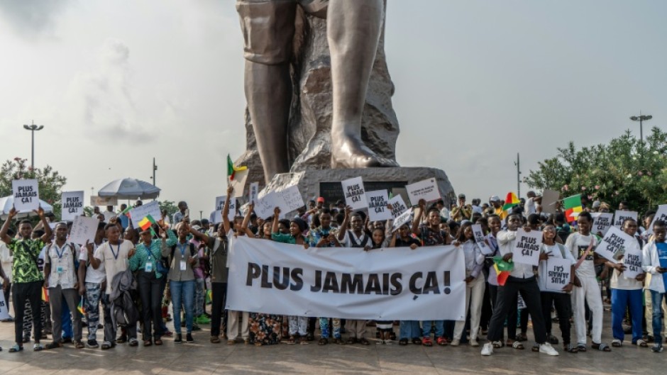 Supporters of Benin's President Patrice Talon waved banners reading 'Never Again' after a failed coup attempt in December