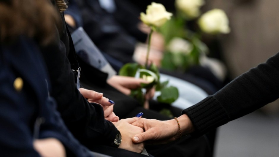 Attendees at the ceremony in Martigny held white roses in memory of the victims of the Crans-Montana fire tragedy