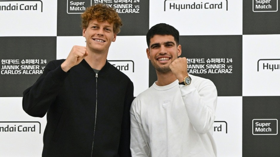 Italy's Jannik Sinner (L) and Spain's Carlos Alcaraz pose for a photo on the eve of their match