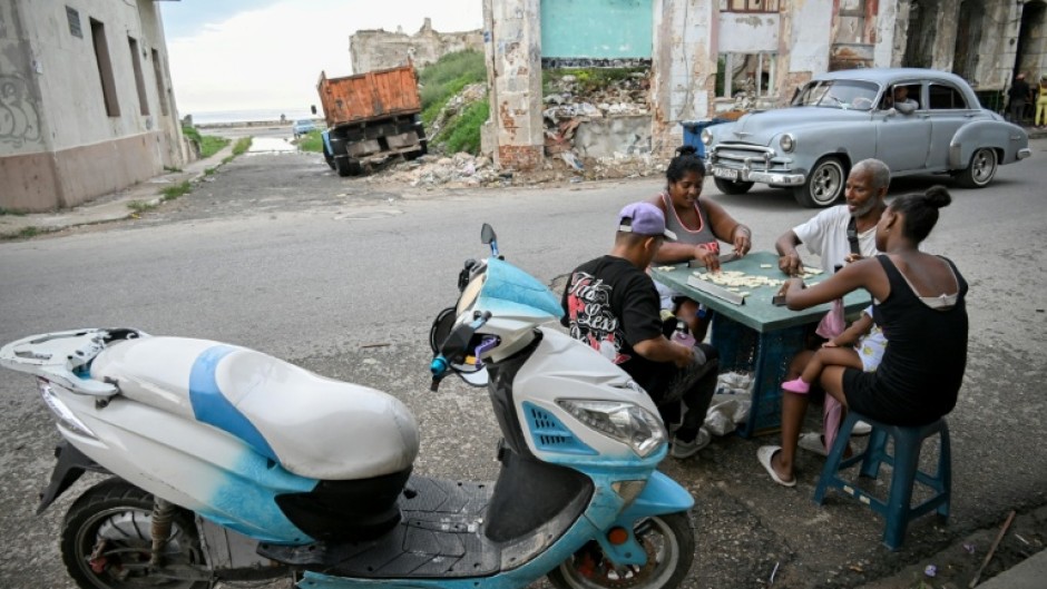 Cubans play dominoes on a street in Havana