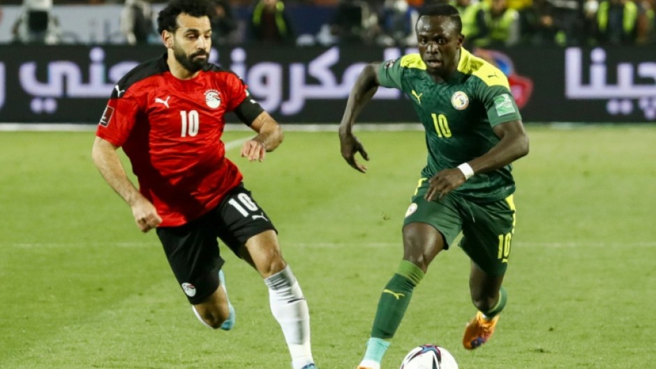 Mohamed Salah (left) and Sadio Mane playing against each other in a World Cup qualifying play-off in March 2022