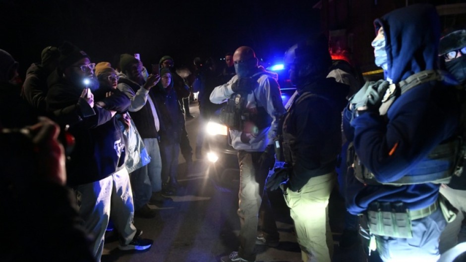 Masked ICE agents and demonstrators face off following the shooting of a Venezuelan man by a Immigration and Customs Enforcement (ICE) agent in Minneapolis, Minnesota