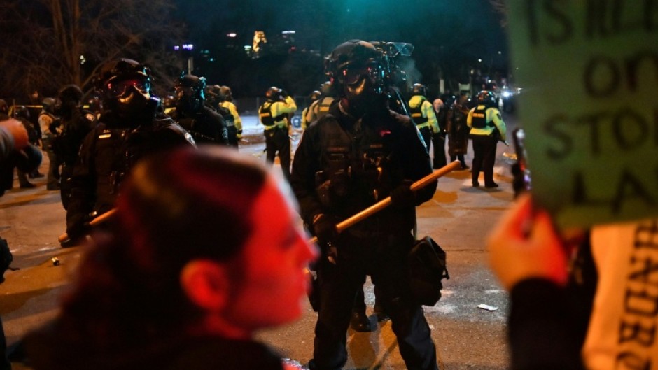 President Donald Trump has threatened to invoke an emergency law allowing soldiers to act as police in response to protests in Minneapolis, where federal agents have shot two people