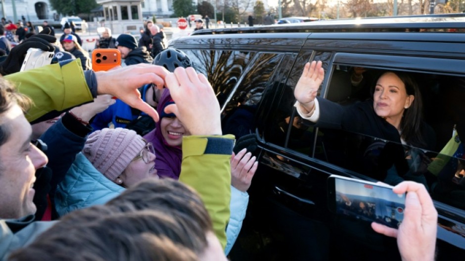 Venezuelan opposition leader Maria Corina Machado waves to supporters from her car as she departs the US Capitol after meeting with US senators on January 15, 2026