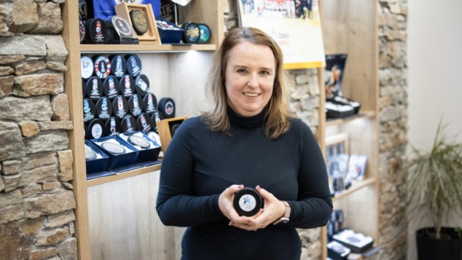 Gufex co-owner Katerina Zubickova poses with an ice hockey puck for the Milan-Cortina Olympics and Paralympics. Her firm will produce 10,000 for the competition and another 10,000 to be sold as souvenirs