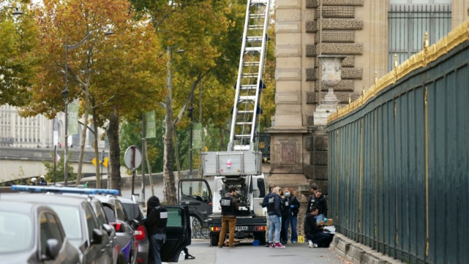 French police officers inspect a furniture elevator used by the thieves