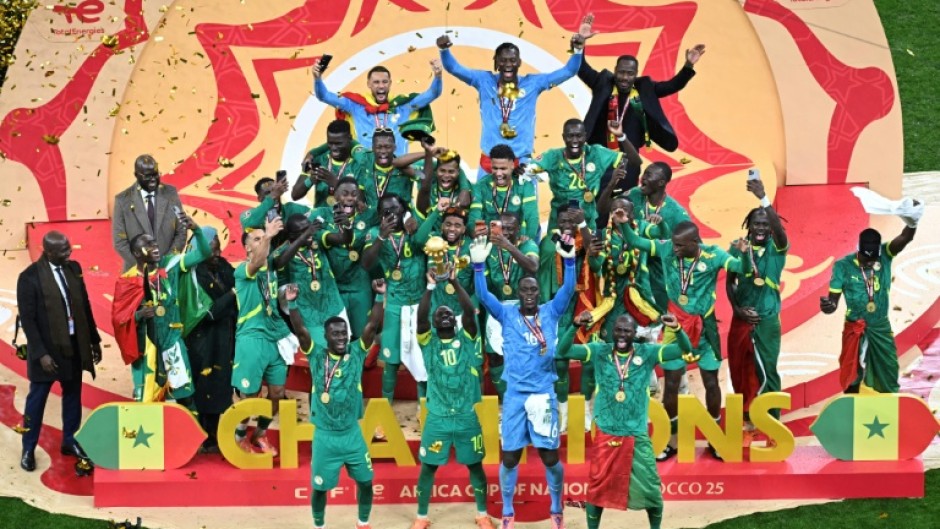 Senegal players celebrate with the trophy after beating hosts Morocco in the final to win the Africa Cup of Nations for the second time in their history