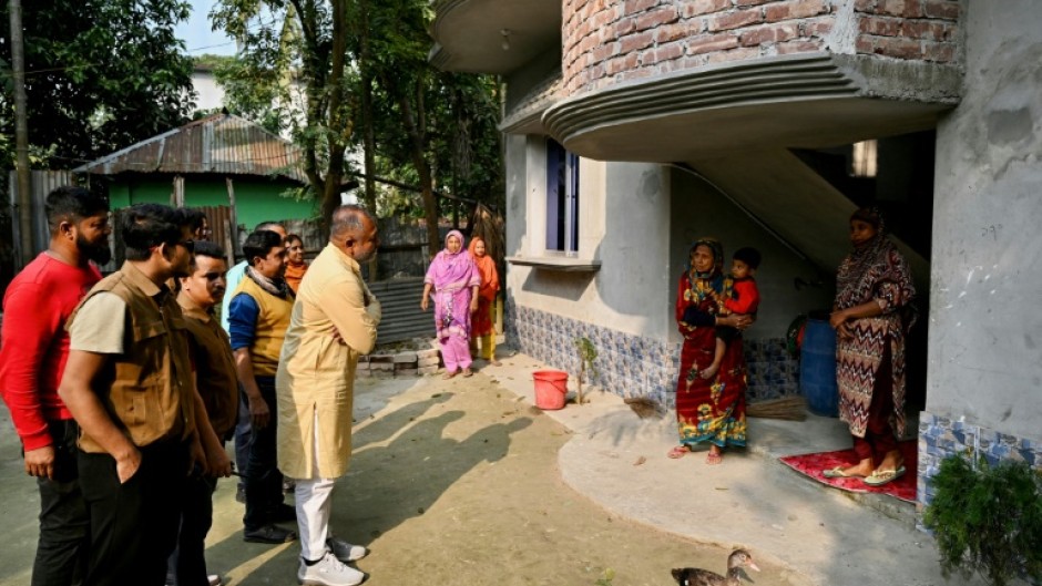 Bangladesh Nationalist Party's election candidate SM Zilany (C) speaking with residents during a visit to his electoral constituency Gopalganj