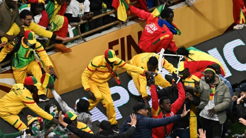 Senegal supporters clash with security forces after a penalty was awarded against their team