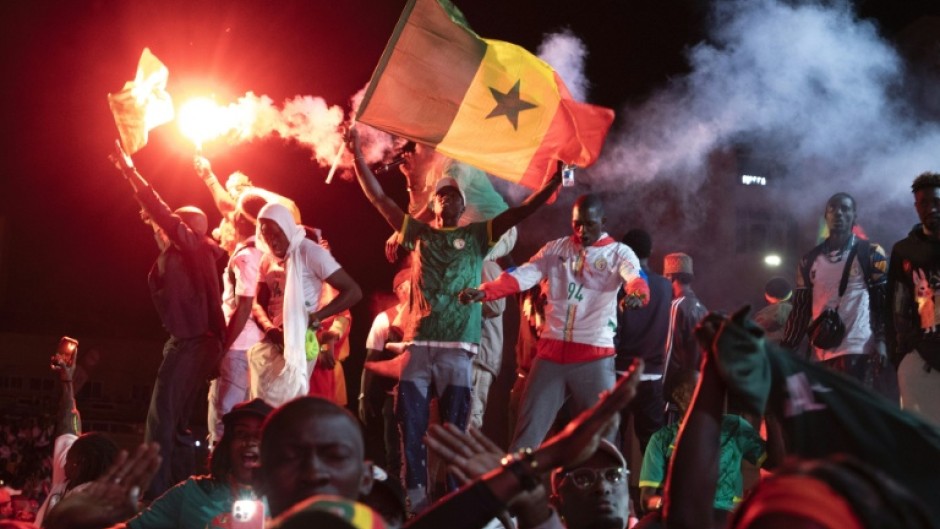 Football supporters celebrate at a 'fan zone' in Dakar on Sunday after Senegal won the Africa Cup of Nations final