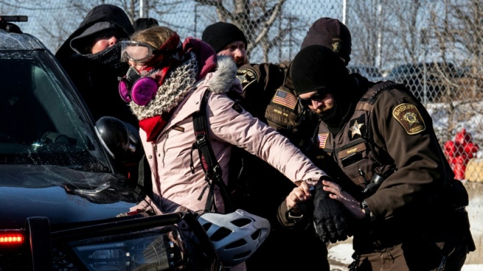 Federal officials claimed that 'agitators' with shields had gathered outside a flashpoint for anti-ICE protests