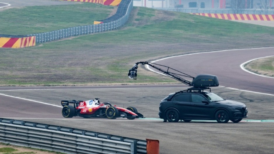 A camera crew film Charles Leclerc in the new SF-26