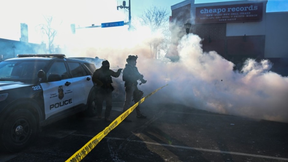 Tear gas is deployed by law enforcement in Minneapolis as demonstrators gather near the site where officials say a man was shot by federal agents