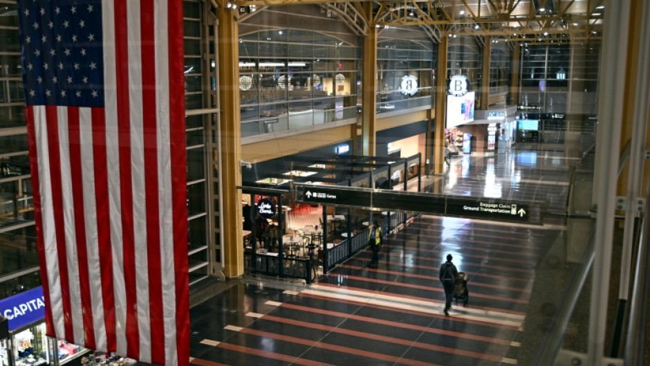 A passenger walks through the check-in area of Ronald Reagan National Airport in Washington, DC, on January 24, 2026, after thousands of flights across the United States were cancelled due to a winter storm