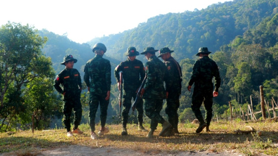 Fighters from Myanmar's rebel Kayan National Army stood guard on a hilltop overlooking a displaced people's camp in Pekon -- as voters went to the polls