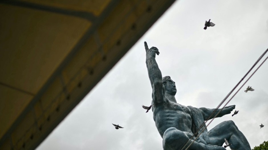 Released doves fly past the "Peace Statue" in Nagasaki, part of a ceremony to mark the 80th anniversary on August 9, 2025 of the world's last nuclear attack