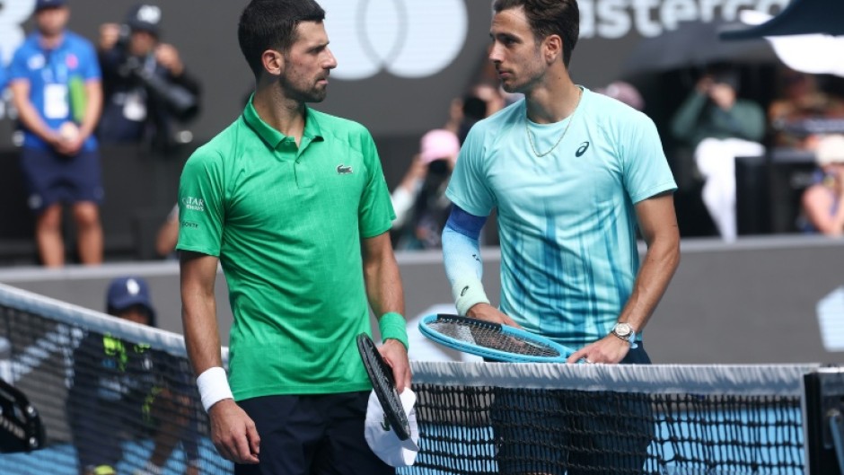 Italy’s Lorenzo Musetti (R) retired hurt in his Australian Open quarter-final against Novak Djokovic