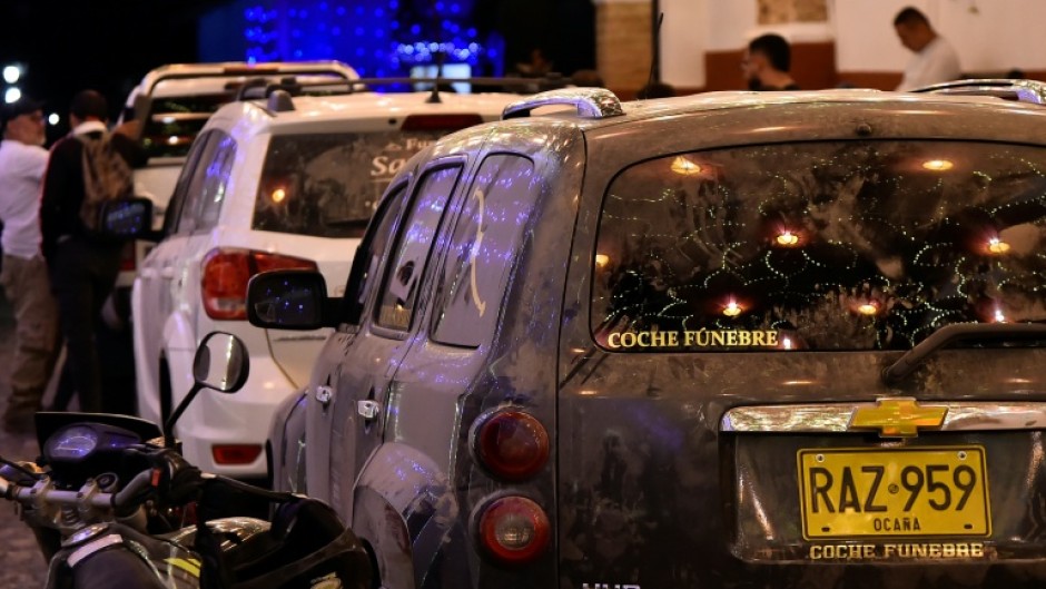 Hearses carrying the bodies some of the 15 passengers killed in the plane crash arrive at La Playa de Belen