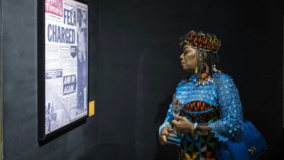 Yeni Kuti, Fela's daughter, looks at a headline on Fela Kuti at the Afrobeat Rebellion exhibition in 2025