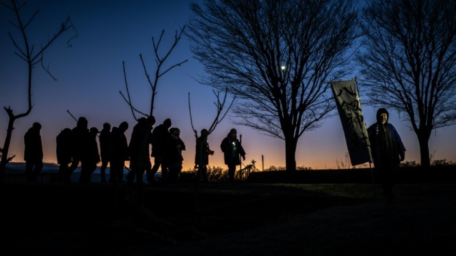 The few dozen men, most in their sixties, were headed to Nagano's Lake Suwa in search of a phenomenon called "God's Crossing"