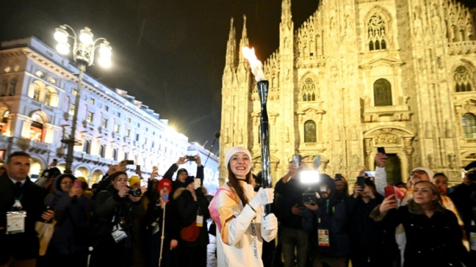 Italian ballet dancer Nicoletta Manni carries the Olympic flame in front of Milan's gothic Duomo ahead of Friday's opening ceremony