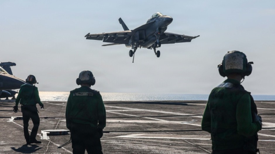 A US naval battle group led by the aircraft carrier USS Abrahem Lincoln is in waters near Iran. (Handout photograph)