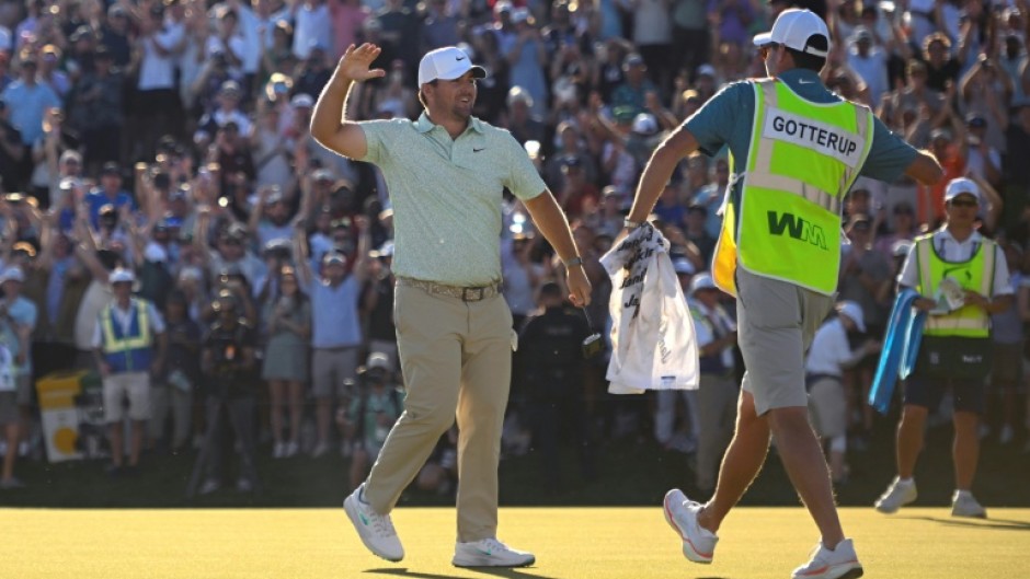 American Chris Gotterup celebrates with his caddie after beating Hideki Matsuyama in a playoff to win the PGA Tour Phoenix Open