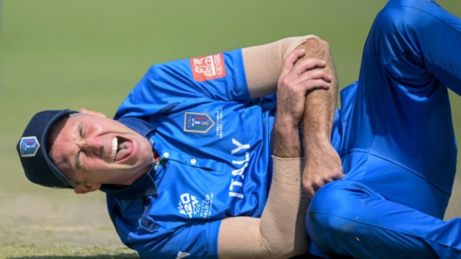 Italy captain Wayne Madsen grimaces in pain after dislocating his shoulder while fielding against Scotland