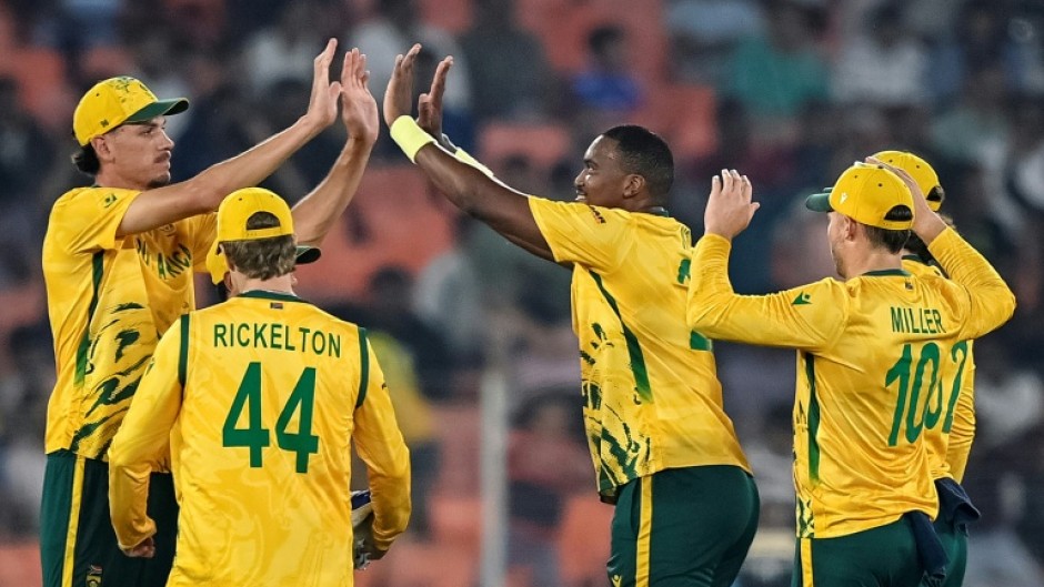 South Africa's Lungi Ngidi (C) celebrates with teammates after taking the wicket of Canada's Yuvraj Samra