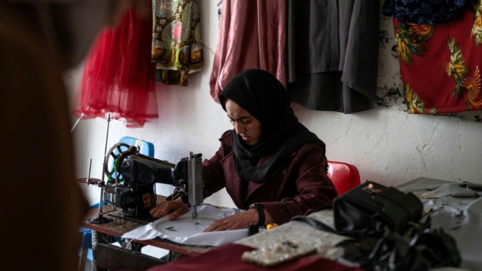 Rahima Alavi embroiders a scarf at her boutique in Bamiyan