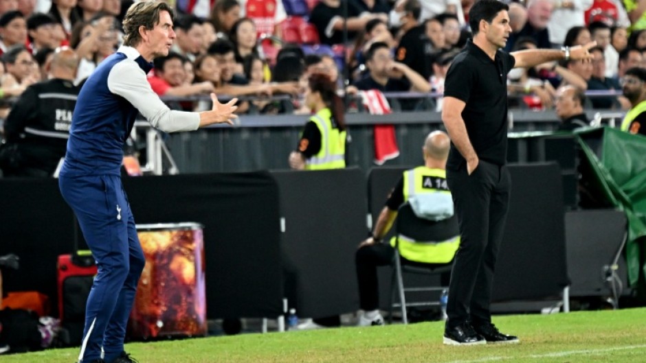 Thomas Frank (L) and Mikel Arteta (R) gesture from the touchline during a pre-season friendly between Tottenham and Arsenal in Hong Kong