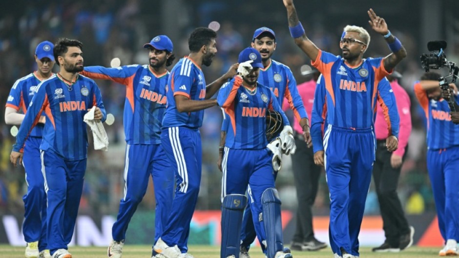 India's Hardik Pandya (R) celebrates with teammates after their win against Pakistan