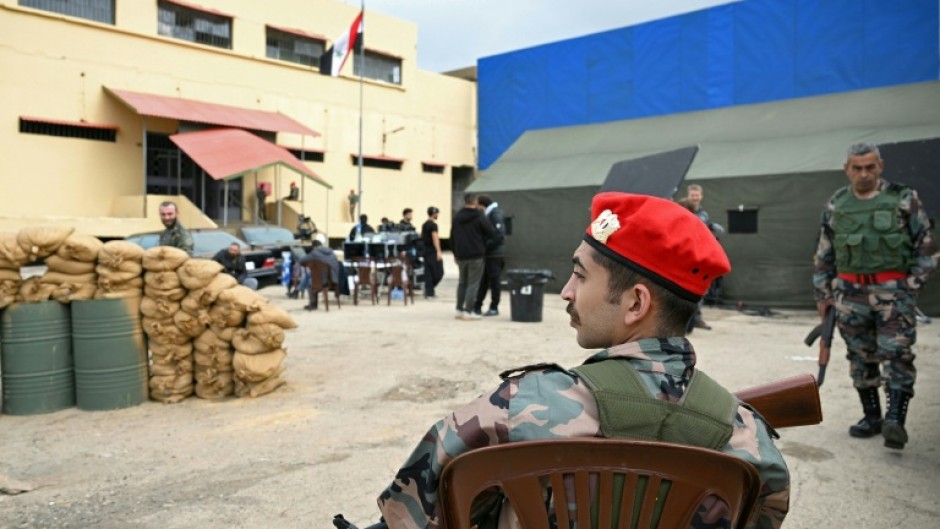 An actor dressed as a former Assad-regime soldier sits on set during the filming of an Arabic TV Series on February 17, 2026