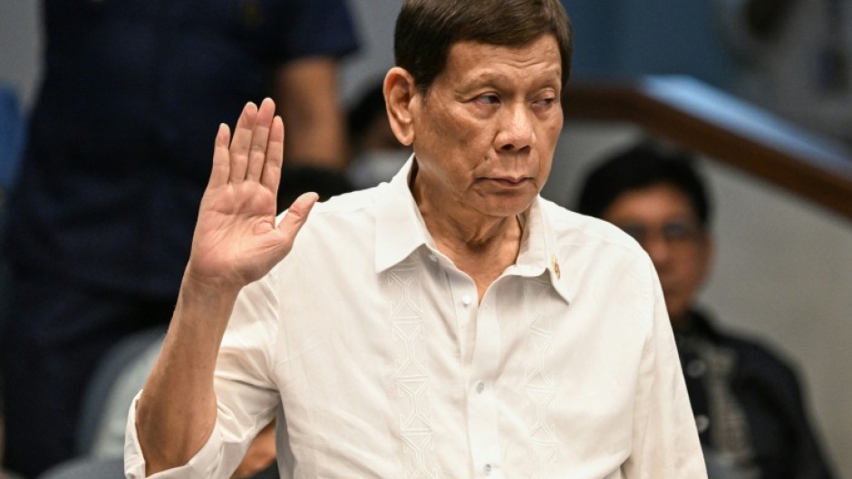 Former Philippine president Rodrigo Duterte takes an oath as he attends a senate probe on the drug war during his administration, in Manila on October 28, 2024