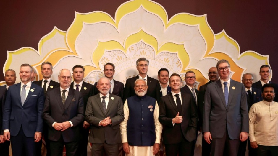 India's Prime Minister Narendra Modi (C), Brazil's President Luiz Inacio Lula da Silva (centre L) and France's President Emmanuel Macron (centre R) and other world leaders and representatives at the AI Impact Summit in New Delhi on February 19, 2026