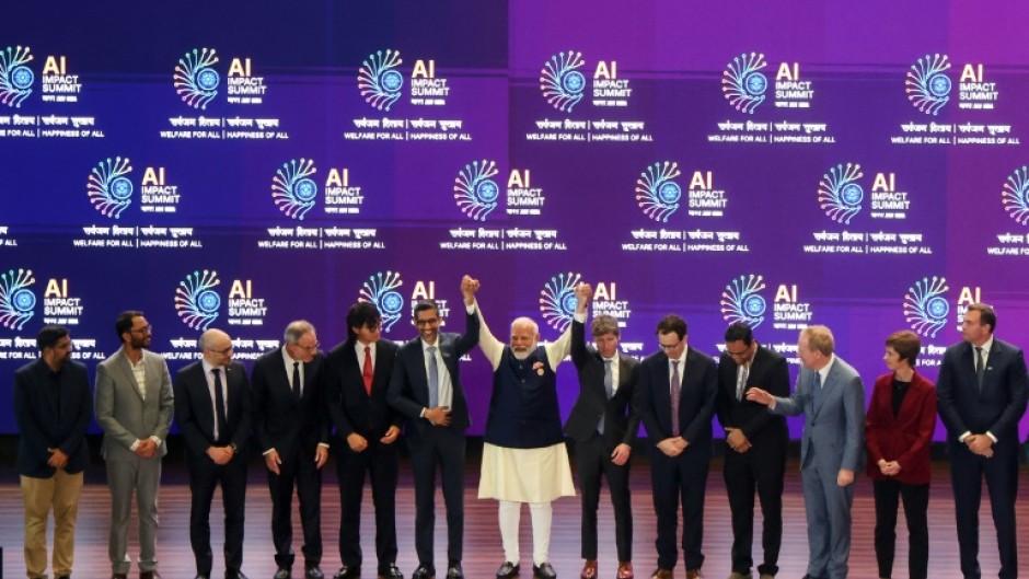 India's Prime Minister Narendra Modi (C) takes a group photo with AI company leaders at the AI Impact Summit in New Delhi on February 19, 2026