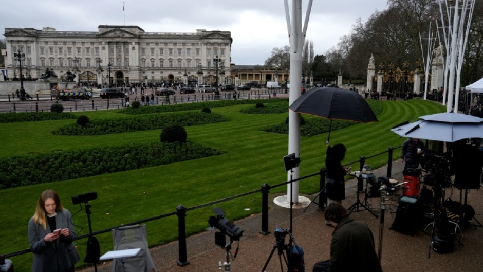 Members of the media gather outside Buckingham Palace in London after the arrest of former prince Andrew