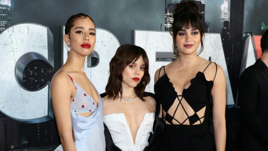 Jenna Ortega (c) and Melissa Barrera (r) will not return for Scream VI after a row about the war in Gaza