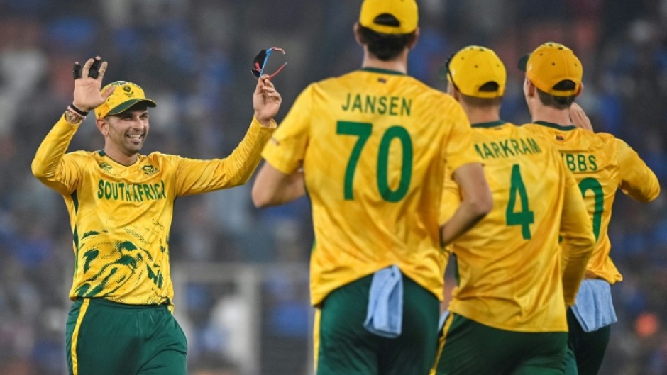 South Africa's Keshav Maharaj (L) celebrates with teammates after taking the wicket of India's Arshdeep Singh.