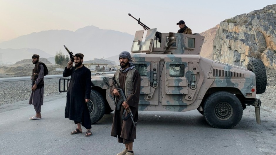 Taliban security personnel stand guard near the Torkham border crossing between Afghanistan and Pakistan in the Nangarhar province