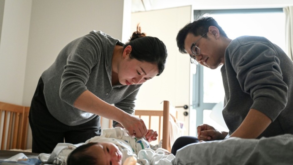Wang Yifan (left) says paediatrician avatars helped answer questions about her baby, reducing trips to hospital