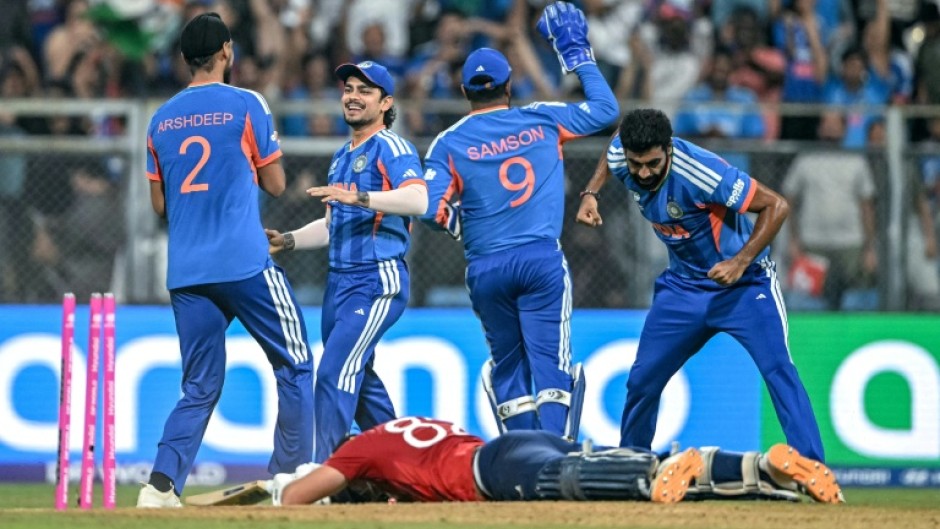 India's players celebrate after the run out of Jacob Bethell for 105 in the final over