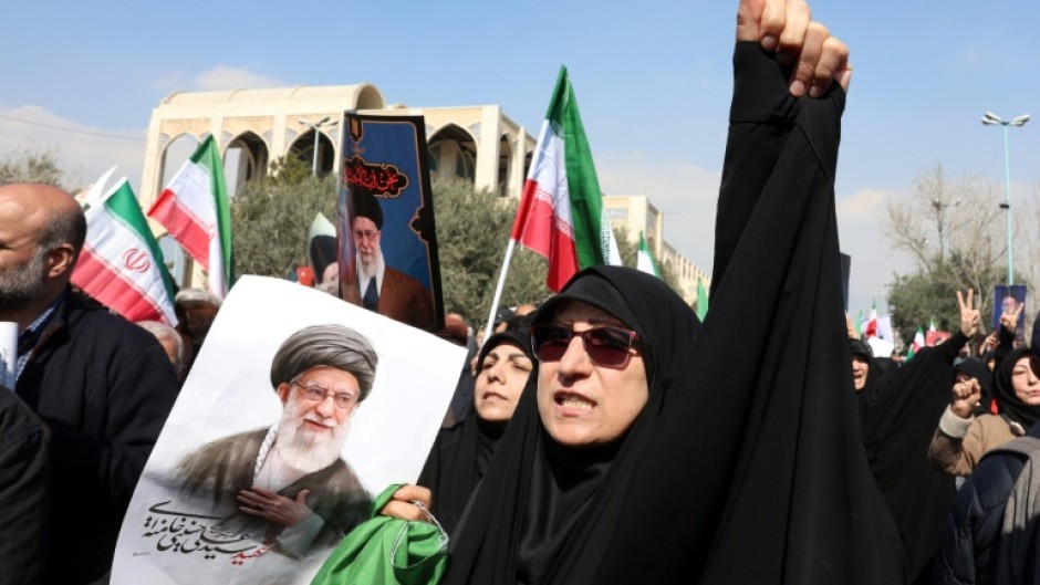 People hold portraits of Iran's slain supreme leader Ayatollah Ali Khamenei as they take part during an anti US-Israel demonstration after Friday prayer in Tehran on March 6
